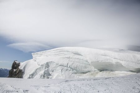 Big snow pack with glacier crevasse on Mont-blanc du Tacul in the French Alps, Chamonix-Mont-Blanc, Franceの写真素材
