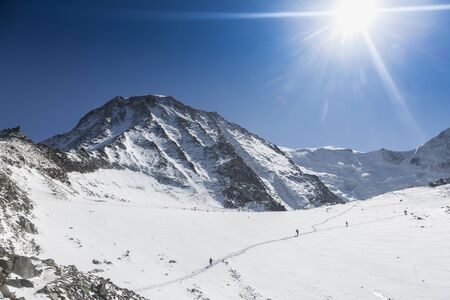 Mountaineering ascending to the Mont-Blanc via Glacier de Tete Rousse and the Grand Couloir is a...