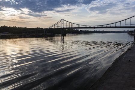 Waves and sky reflection under the bridge on Dnipro river, Kyiv city, Ukraineの写真素材