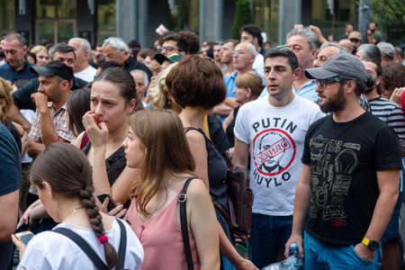 Tbilisi, Georgia - June 20, 2019: A man a t-shirt in Putin Huylo. Anti Russian protests in front of the Parliament of Georgia.のeditorial素材