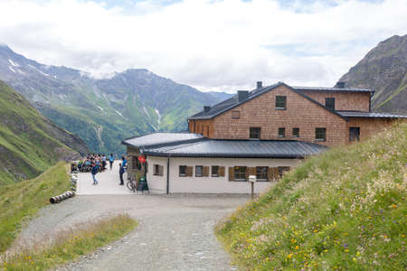 Tourist are resting near Luckner-Haus or Lucknerhutte near the Grossglockner rock summit in Austrian Alps, Kals am Grossglockner, Austriaのeditorial素材