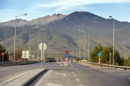 Road in the mountains. Lots of road signs and lights