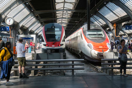 Zurich, Switzerland - 1 August, 2019: tourist are waiting near the modern swiss transport trains at the stationのeditorial素材