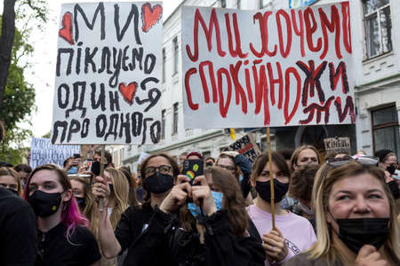 KYIV, UKRAINE - May 21 2021: protest action against police's abuse of power. The inscription on the poster held by the activist:"We take care of each other"のeditorial素材