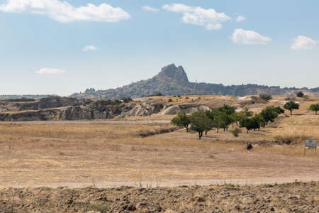 Aerial of the town of Goreme with the Rock Castle of Uchisar on the horizon, Cappadocia, Anatolia,...