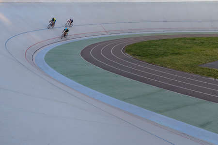 Three cyclists compete on a cycle track in a circle in Kyiv, Ukraine