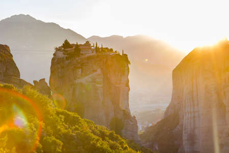 The Greek miraculous monastery in a sun light on the rock formation during sunset, Meteora, Greece....