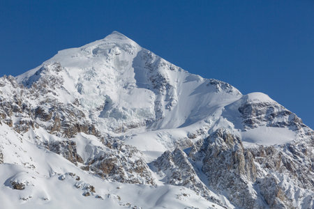 A Tetnuldi mountain slope covered with snow and glaciers, Caucasus Mountains, mountaineering in Georgiaの写真素材