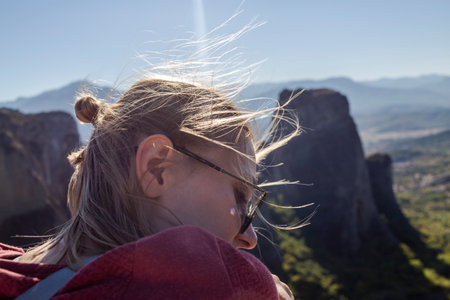 A woman with blond hair in a headshot portrait, focusing on the foreground nature.の写真素材