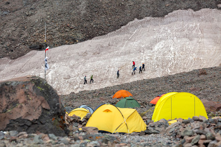 Vibrant Base Camp: A community of explorers prepares for their ascent, their tents dotting the landscape like colorful wildflowers.の写真素材
