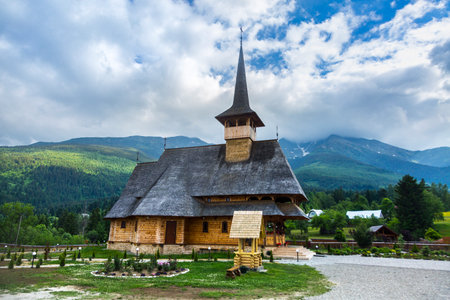 Old Romanian wooden church of MaramureÈ™, Romania. High timber constructions with characteristic...