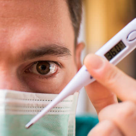 Doctor with mask and thermometer in Italyの写真素材