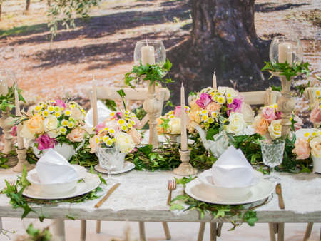 A table set with beautiful floral arrangements for a wedding