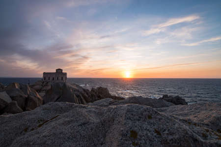 Sunset at the Capotesta lighthouse in Sardiniaの写真素材