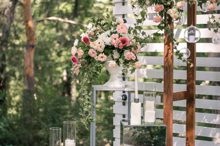 Wedding ceremony. Very beautiful and stylish wedding arch, decorated with various fresh flowers, standing in the garden. Wedding day. Fresh flowers decorations, Peony weddng.の写真素材