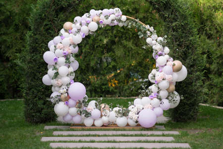 Ouside wedding ceremony. Balloon wedding arch in the garden. Wedding day.の写真素材