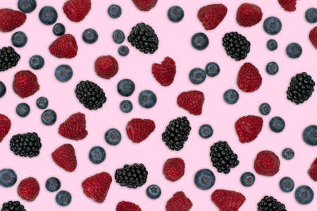 Berries pattern isolated on light pink. Strawberries, raspberries blackberries and blueberries arranged on light pink. Top view.の写真素材