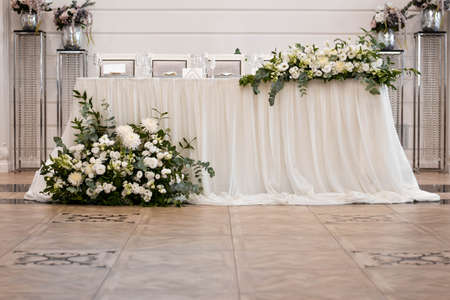Main table at a wedding reception with beautiful fresh flowersの写真素材