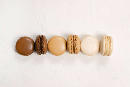 Vanilla, caramel and chocolate macaroons on white background.の写真素材