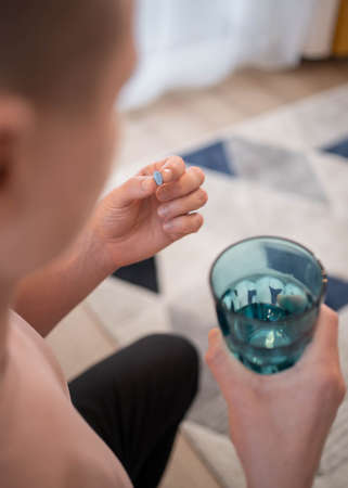 A young man takes a prep in a pill. HIV prevention concept. AIDS prevention concept. HIV AIDSの写真素材