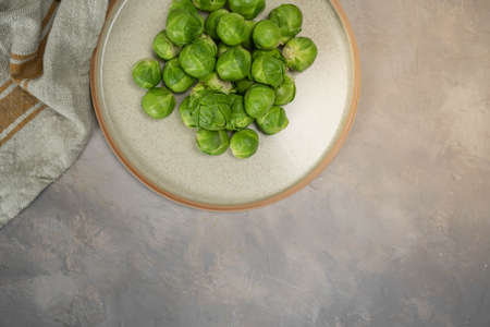 Plate with fresh Brussels cabbage on table, top view.の写真素材