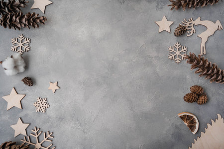 Christmas composition. Christmas decorations, pine cones, fir branches on gray stone background....