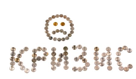 Inscription crisis and a sad smiley face lined from coinsの写真素材