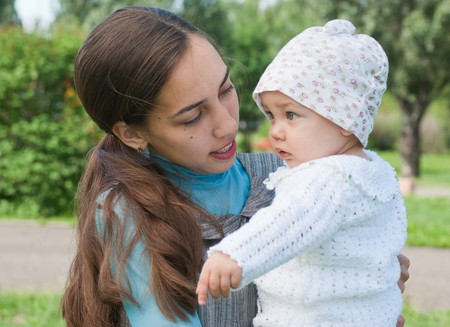 My mother looks at her daughter, walking in the parkの写真素材