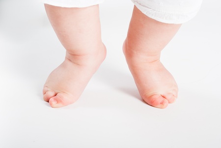 Small legs of the child on a white background