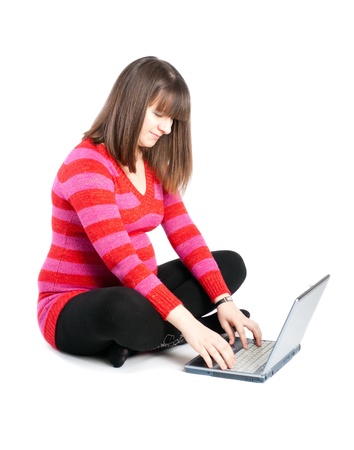 The pregnant woman works behind the laptopの写真素材