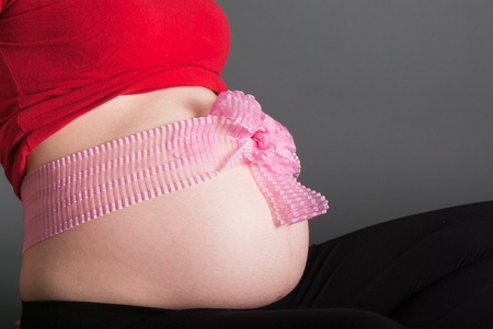 Stomach of the pregnant woman tied up by a ribbon
の写真素材