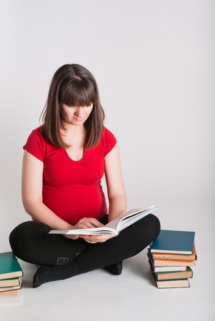 The pregnant woman reads many booksの写真素材
