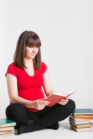 The pregnant woman reads many booksの写真素材