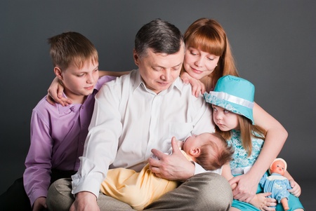 All family looks at the babyの写真素材