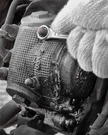 Leaking engine being checked and troubleshoot by a mechanic.の写真素材