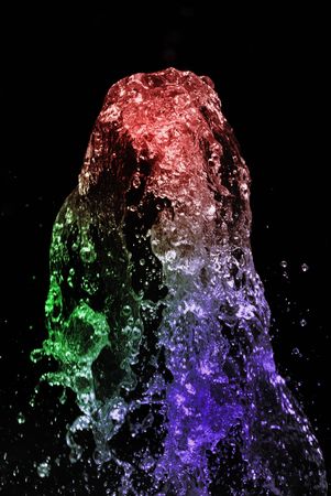 water jet colored spray squirt on black backgroundの写真素材