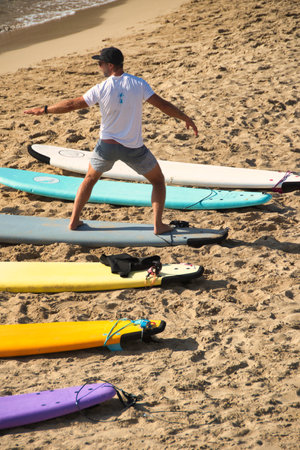Surf instructor shows you how to stand on the board