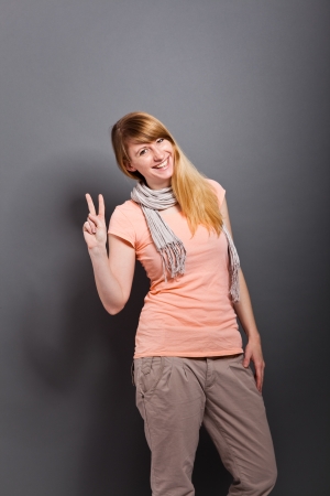 young, handsome woman with victory poseの写真素材