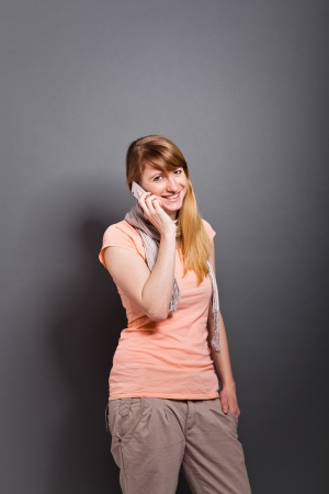 young, handsome woman with cellphoneの写真素材