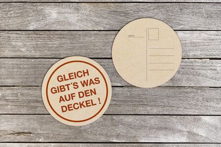 Two beermats on a tableの写真素材