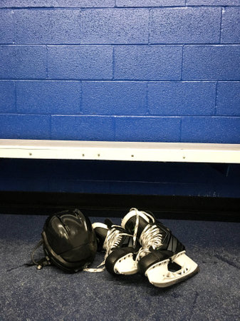 Hockey skates and helmet in locker roomの写真素材