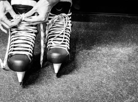 Tying ice skate lacesの写真素材