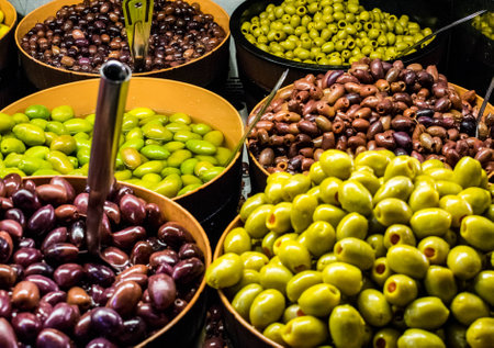 Mixed olives in bowls in the marketの写真素材