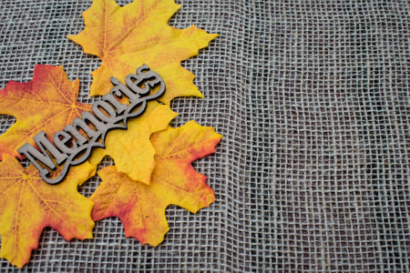 Autumn leaves decoration in burlap background with memories tagの写真素材