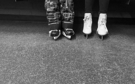 Kids hockey and figure skates in locker room in black and whiteの写真素材