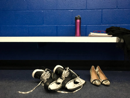 Womenâs hockey skates game after work with heels in locker room with copy spaceの写真素材