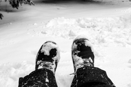 Two feet sitting on snowy background with copy spaceの写真素材