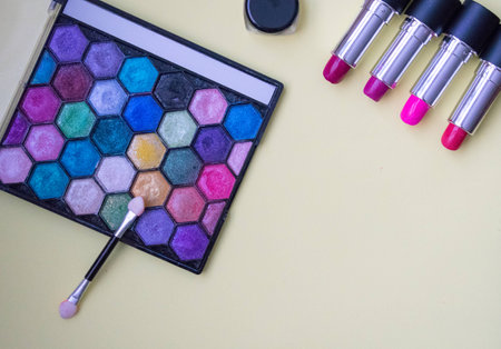 Top view of bright shiny make up, eye shadows, lipsticks with copy spaceの写真素材