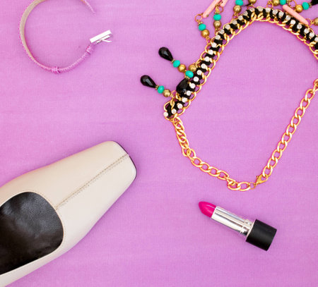Top view of woman beauty accessories shoes, lipstick, necklace, bracelet with text spaceの写真素材