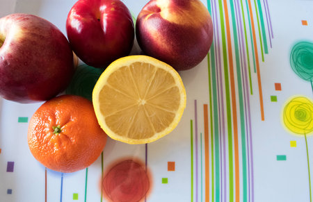 Fresh unpeeled fruits in colorful background with copy spaceの写真素材